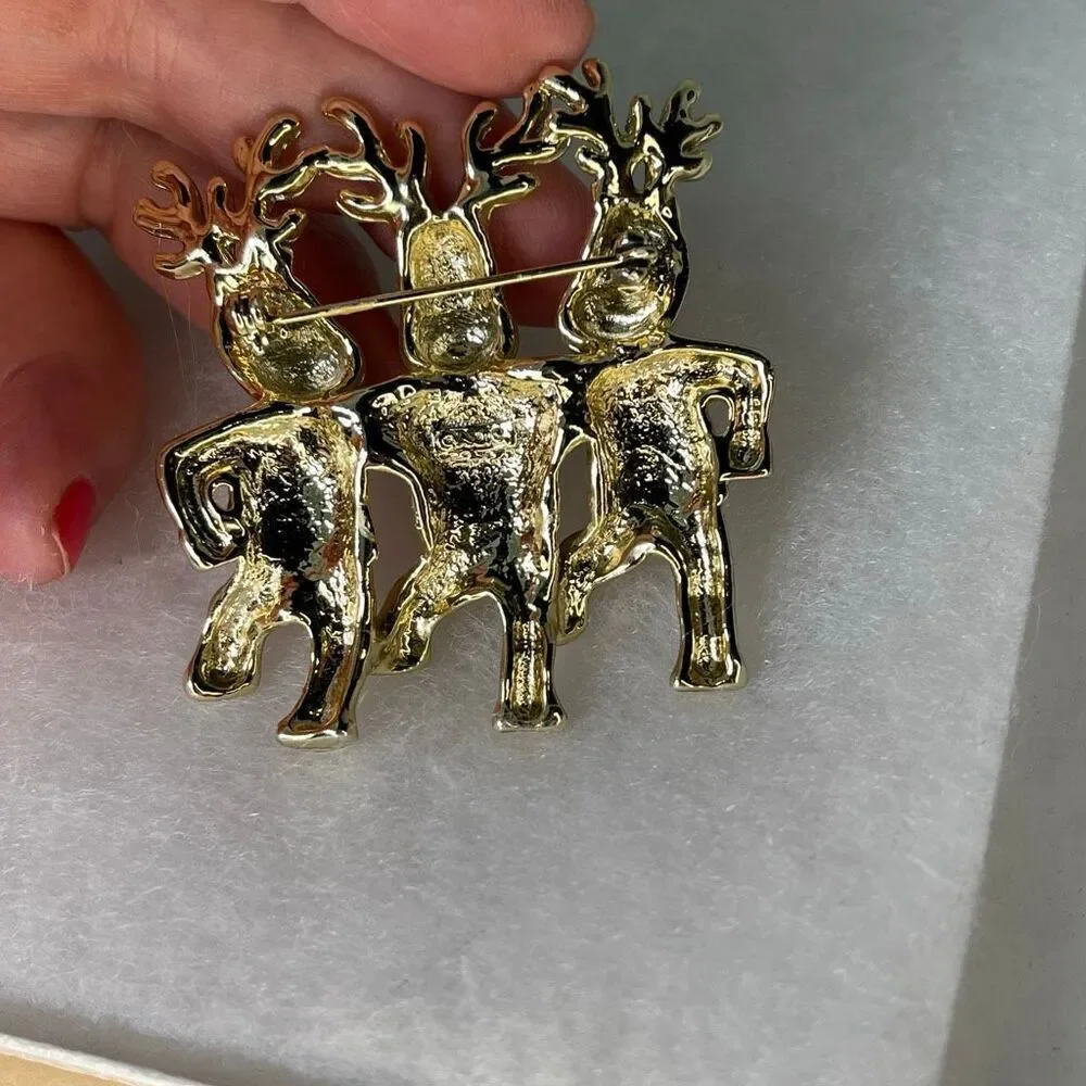 Vintage AJC three dancing deer gold tone brooch.